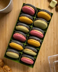 Tuinposter Vertical top view of colorful French macarons in a box over the wooden surface © Pjm Captures/Wirestock Creators