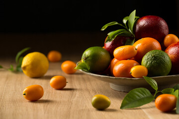 A variety of tropical citrus fruits on a ceramic plate