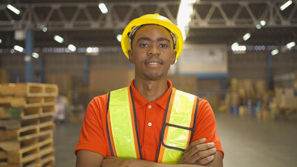 Portrait of black worker working in large warehouse retail store industry. Rack of stock storage. Interior of cargo in ecommerce and logistic concept. Depot. People lifestyle. Shipment service.