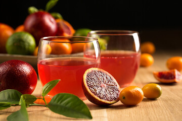 Still life with two glasses with a citrus drink on a fruit background