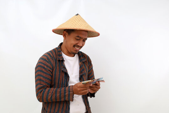 Happy Asian farmer standing while holding a cell phone. Isolated on white background with copyspace
