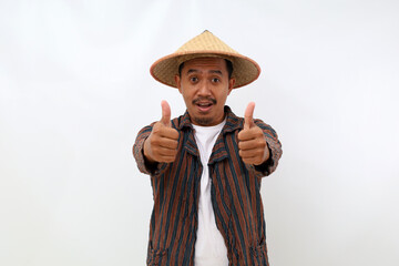 Happy asian farmer standing while showing thumbs up. Isolated on white background