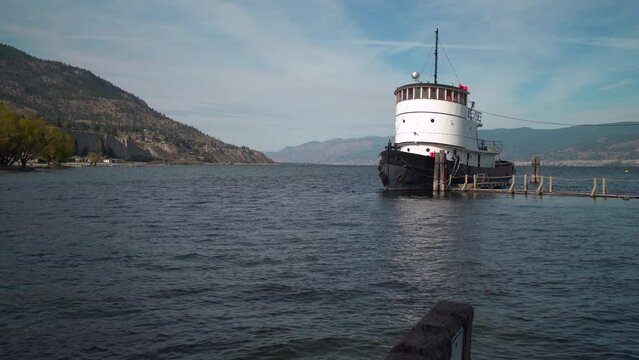 Okanagan Lake Penticton Historic Tugboat 4K UHD. The historic tugboat, moored just offshore on Lake Okanagan, is one of the vessels in the Inland Marine Heritage Park. 4K UHD.
