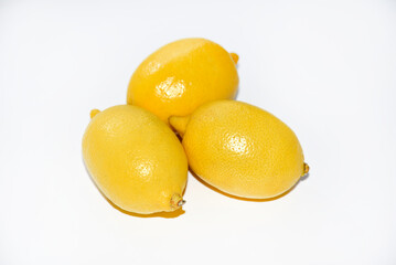 Yellow ripe lemon on a white background. Juicy lemons close-up. Isolate of the fruit of a yellow lemon.
