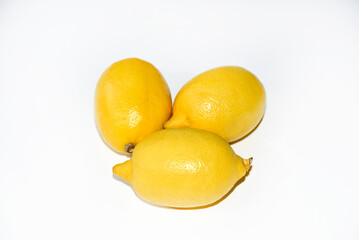 Yellow ripe lemon on a white background. Juicy lemons close-up. Isolate of the fruit of a yellow lemon.