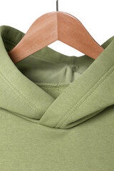 Green sweatshirt hanging on a wooden hanger front view. The concept of modern comfortable sportswear.