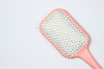 Pink hairbrush isolated on white background