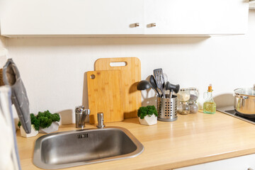 Fototapeta na wymiar Scandinavian classic minimalistic kitchen with white and wooden details. Modern white kitchen clean contemporary style interior design
