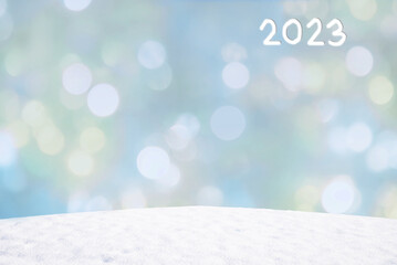wintry background with flares and snowy hill, space for text, 2023 year