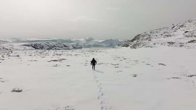 Aerial Shot Of A Man Looking Towards A Long Snowy Path