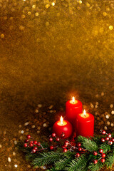 Christmas picture three candles and fir branches on a dark green background