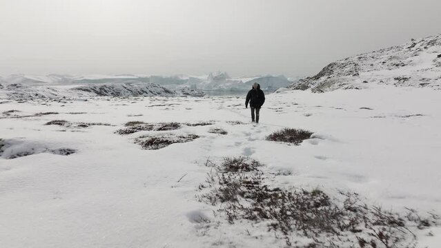Extreme Wide-Shot Of Man Following The Footprints On The Snow