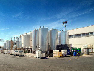 chemical industry exterior with steel silos and plastic containers for liquids

