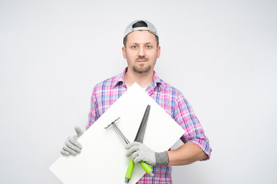 Male gardener holding gardening tools and white board, isolated on white background. Promoter male farmer showing blank empty paper billboard with blank space for text