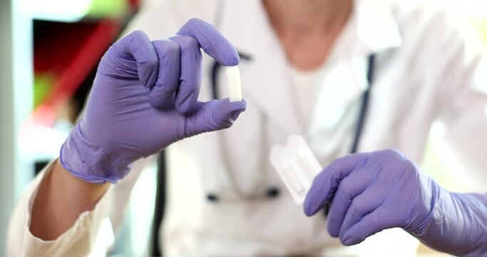 The woman is holding vaginal and anal suppositories