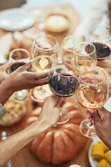 Wine, cheers and glasses at christmas toast, holiday celebration with food, friends and family together. Hands, wine glasses and friendship, celebrate diversity at dinner party with men and women.