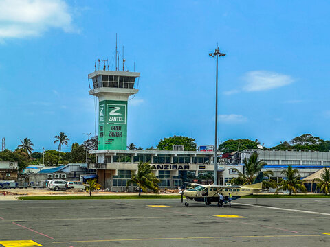 Zanzibar, Tanzania - Nov. 2022, Air Traffic Control Tower and old Terminal Building at "Abeid Amani Karume International Airport" Zanzibar with Cessna Caravan parked in front of Terminal.