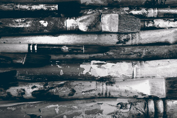 Row artists of Paintbrush closeup, black  & white, lying horizontally, dirty, soiled with oil paint, nobody
