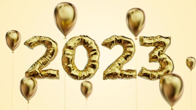 2023 title made of foil gold material among balloons with depth of field.