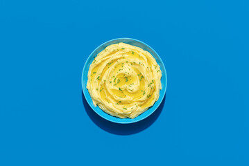 Mashed potatoes above view on a blue background
