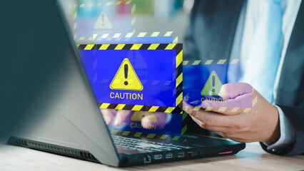 Businessman or it staff , programmer, developer using computer laptop with triangle caution warning...