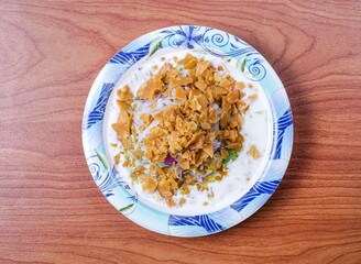 mixed papdi chaat with onion and dahi served in dish isolated on table top view of indian and pakistani food