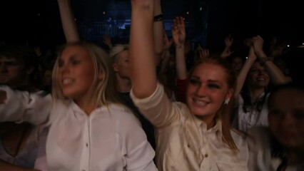 Festival, music and crowd dance jump for rave, edm or techno club beats moving with excited energy. Music festival, concert and happy women dancing together at musical live performance event.