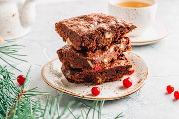 Christmas brownies with walnut and cranberry on gray marble background. Sweet winter holiday food