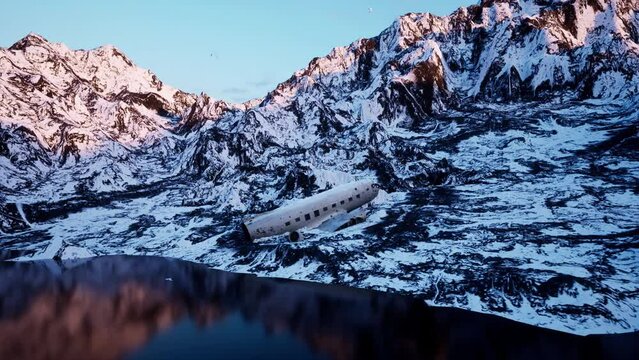 The wreckage of an unbranded commercial airplane that crashed into the side of a snow-covered mountain range.