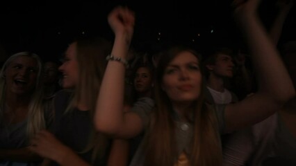 Party, concert and crowd at a disco dance event or music festival dancing with friends at a nightclub together. Freedom, rock or excited house fans in a crazy audience in a fun rave punk celebration