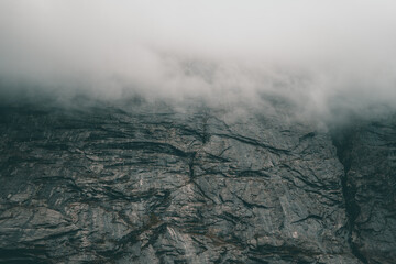 Fototapeta premium Beautiful mountain with some fog and clouds on it Background