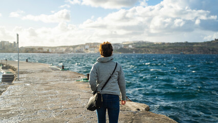 young girl walk ships buildings beautiful mediterranean sea malta island sand stones sun cacti - obrazy, fototapety, plakaty