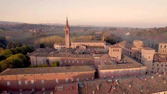  4K drone footage orbital flight of Castelvetro di Modena medieval village in Emilia Romagna during sunrise on a cold Fall morning