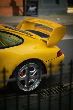 Vertical Shot Of A Yellow Porsche 911