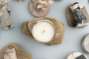 candles and handmade decor on a blue background, business for moms on maternity leave, space for text, top view