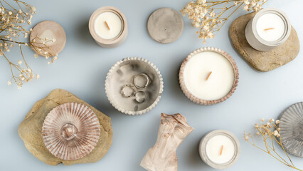 candles and handmade decor on a blue background, business for moms on maternity leave, space for text, top view