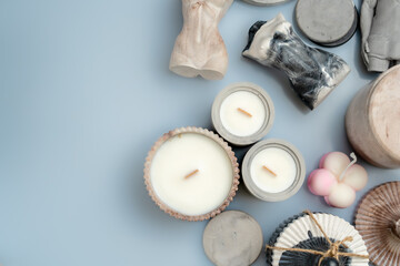candles and handmade decor on a blue background, space for text, top view