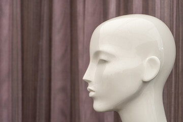 A female mannequin in a suit on a shop window. Sale of modern fashionable clothes. Bright youth clothing wholesale and retail.