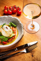 Burrata italian cheese snack with tomatoes served on white plate