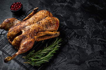 Roast whole duck, festive christmas recipe. Black background. Top view. Copy space