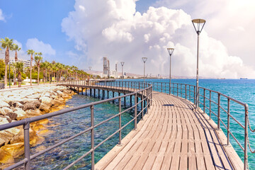 Molos Promenade in Limassol city in Cyprus . View of landmark with palm trees, pools of water, the...