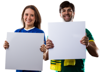Brazilian couple holding white empty boards, cheering for Brazil to be the champion.