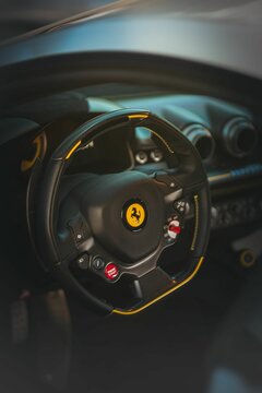 Vertical shot of a Ferrari F12 TDF interior with the steering wheel in focus