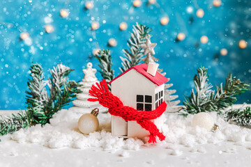 Abstract Advent Christmas Background. Toy house with knitted scarf with snow and winter decorations...