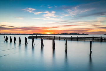 Obraz premium Poles standing in water at empty harbour