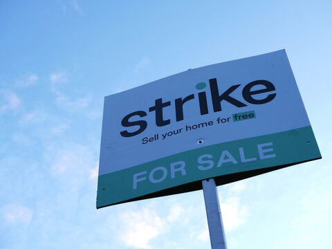 Real estate agent for sale sign against blue sky 