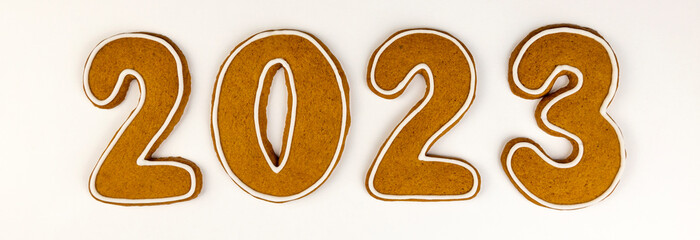 Gingerbread cookies in the form of numbers 2023 in the center on a white background. New year...