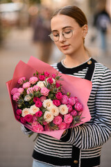 view on attractive woman with bouquet in her hands