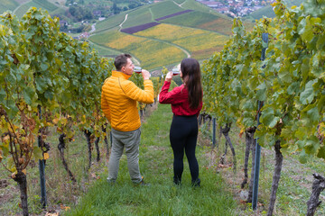 Glückliches Paar am Wein trinken in den Weinbergen