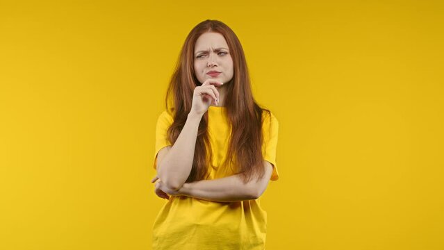 Young pensive woman having idea eureka moment, pointing finger up on yellow background. Smart student girl showing answer gesture or remembered what she forgot, memory concept
